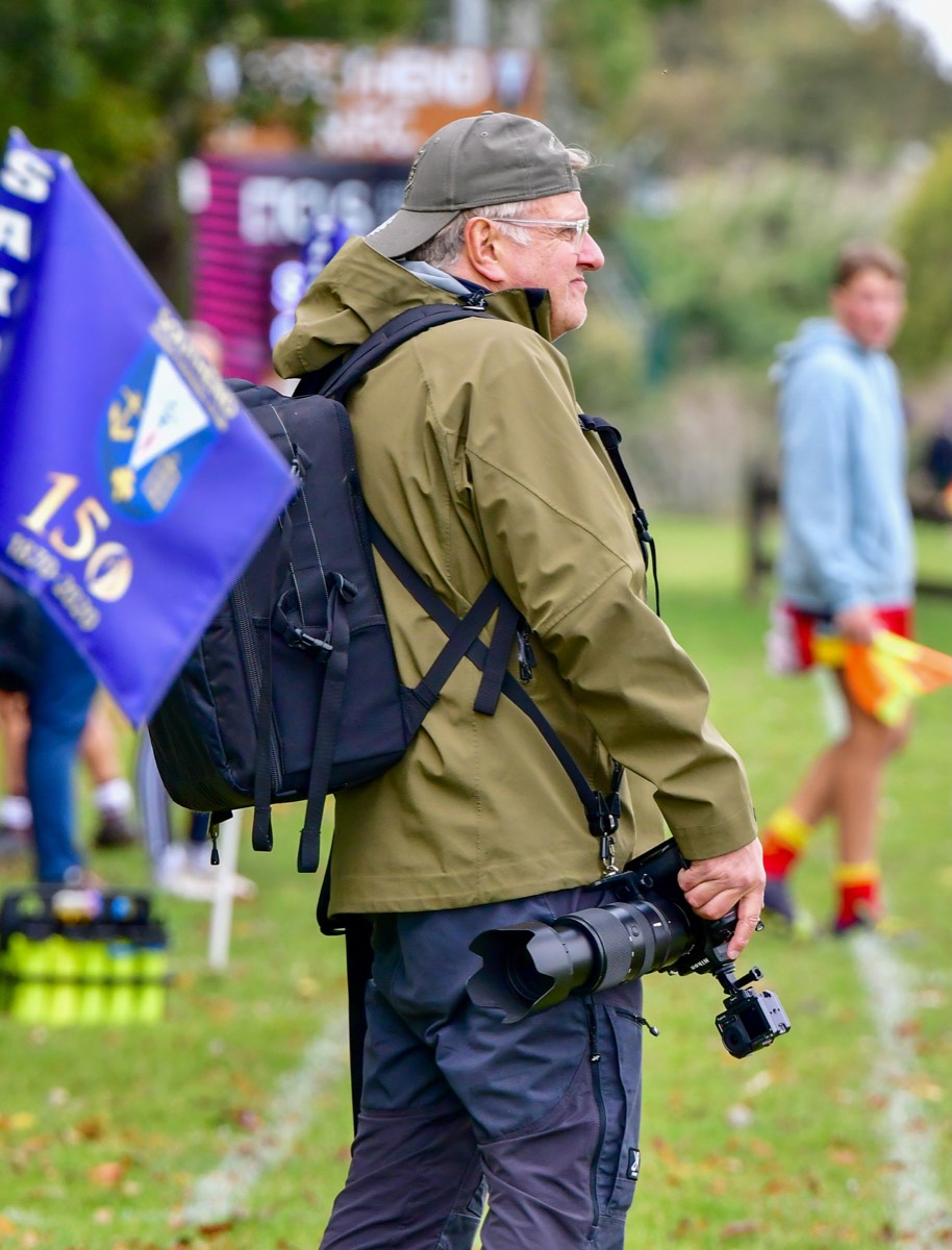 Jon Wagstaff holding his camera on the sideline at a sports event